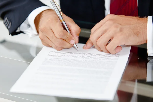 Businessman writing on a form Royalty Free Stock Images