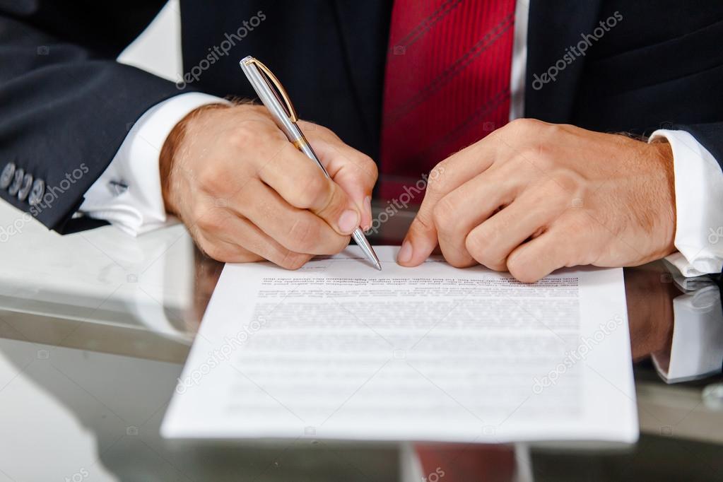 Businessman writing on a form