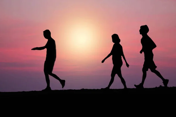 Family Running Jogging Red Sky Background — Stock Photo, Image