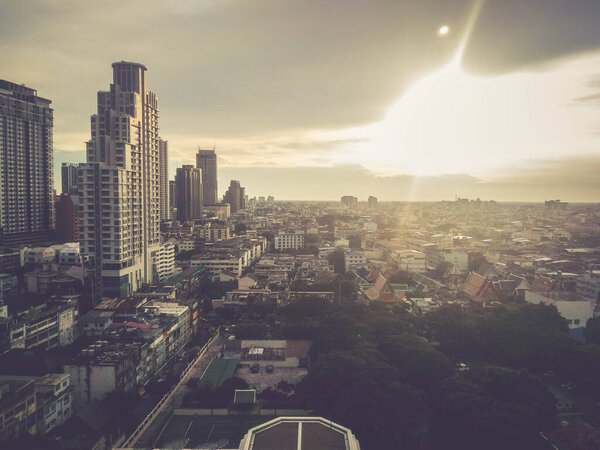 Blurred city building in Bangkok with sunlight