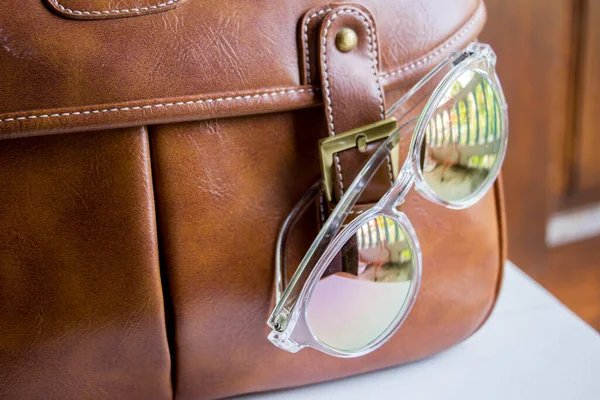 retro leather bag with sun glasses