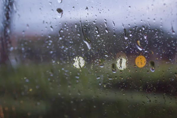 Abstraktní rozostření fotografie dešťové kapky na okno auta — Stock fotografie