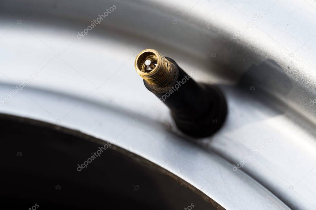 Close-up of a nipple without a cap on a car wheel.