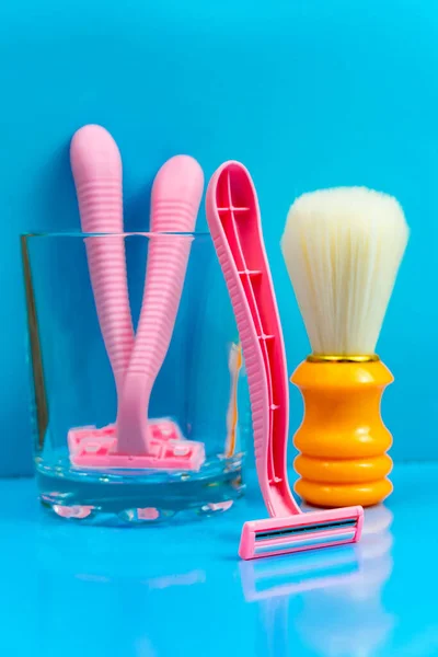 Shaving Products Blue Bathroom Orange Shaving Brush Pink Razors Glass — Stock Photo, Image