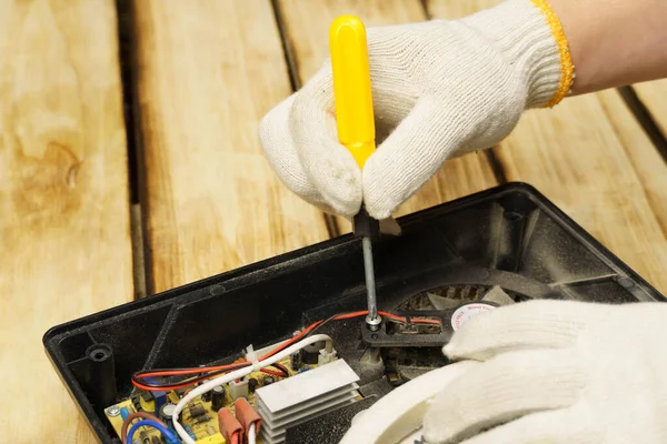 Mästaren Vrider Skruven Den Elektriska Spisen Med Skruvmejsel Träbakgrund Händerna — Stockfoto