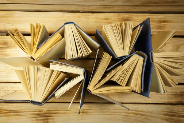 Top view of old hardback books on wood background. Background from books. Open books, flipped pages. World Book and Copyright Day.