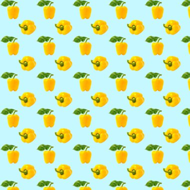 Dolmalık biber deseni. Mavi arka planda sarı dolmalık biber. Organik sebzeler, sağlıklı malzemeler..