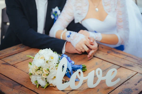 Bride and groom with word Love — Stock Photo, Image
