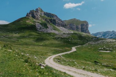 Durmitor dağları, Ulusal Park, Akdeniz, Karadağ, Balkanlar ve Avrupa 'da günbatımı manzarası. Sedlo Geçidi 'nden parlak yaz manzarası. Instagram fotoğrafı. Dağlardaki evin yanındaki yol..