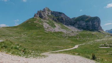 Durmitor dağları, Ulusal Park, Akdeniz, Karadağ, Balkanlar ve Avrupa 'nın muhteşem manzarası. Sedlo Geçidi 'nden parlak yaz manzarası. Dağlardaki evin yanındaki yol..