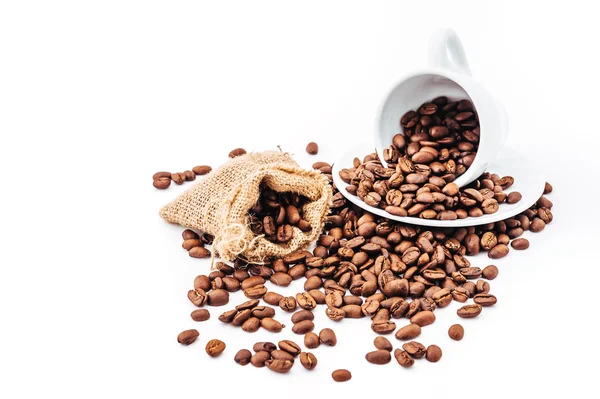 White cup with coffee beans isolated — Stock Photo, Image