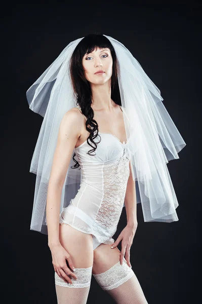 Sexy beautiful nude bride with veil in white erotic lingerie on a black background. beauty portrait of woman — Stock Photo, Image