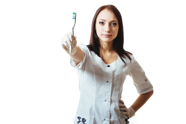 Woman Dentist with toothbrush. Smiling female doctor holding toothbrush  isolated on white background — Stock Photo, Image