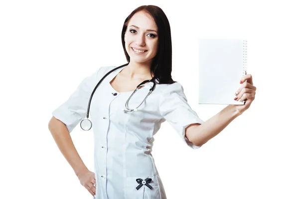 Portrait of happy smiling young female doctor showing blank signboard, isolated over white background — Stock Photo, Image