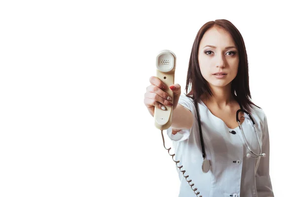 Woman in scrubs holding a telephone — Stock Photo, Image