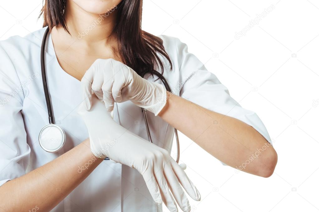 Doctor putting on white sterilized medical glove for making operation. woman wears latex surgical gloves