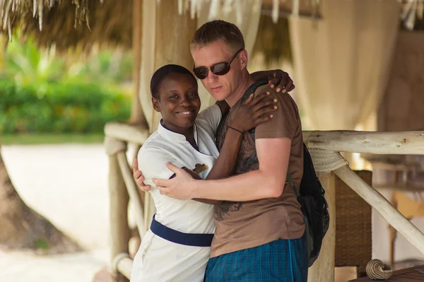 Young multi-ethnic couple on romantic tropical beach — Stock Photo, Image
