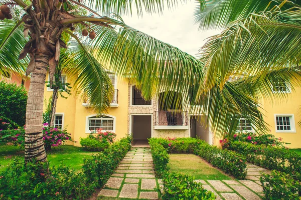 Luxurious villa in Dominican Republic, own swimming pool. Caribbean resort with beautiful garden. Classical spanish house among flowers — Stock Photo, Image