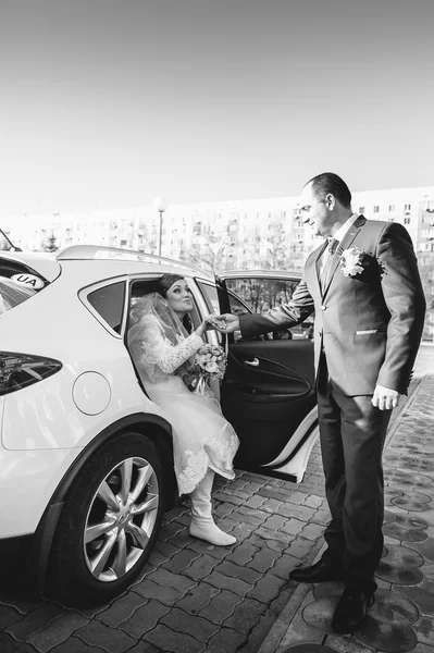 Bride and groom near vintage decorated car on wedding day. — Stock Photo, Image