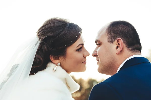 Noiva feliz e noivo em seu dia de casamento em um parque. Vestidos nupciais e buquê de flores . — Fotografia de Stock