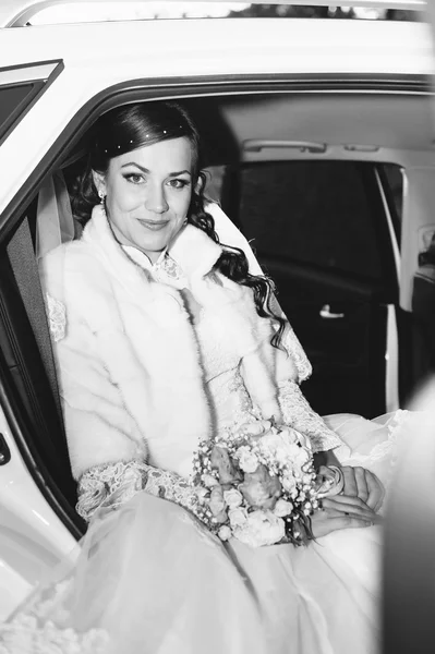 Close-up portrait of pretty shy bride in a car window — Stock Photo, Image