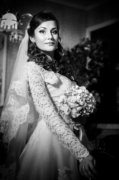 Splendida sposa bionda in abito da sposa su interni di lusso con gioielli di diamanti in posa a casa e in attesa di sposo . — Foto Stock