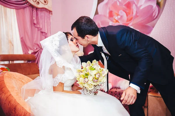 Young newlyweds kiss and enjoying romantic moment together at wedding day — Stock Photo, Image