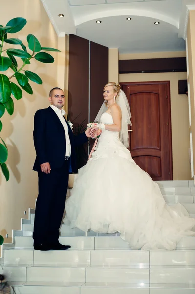 Gelukkig jonge bruid en bruidegom op hun trouwdag. Bruidspaar - nieuwe familie. trouwjurk. Bruids bruiloft boeket van bloemen — Stockfoto