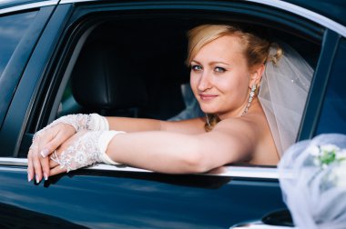 Arabanın içinde güzel bir gelin portresi. bir çok utangaç gelin bir araç penceresinde yakın çekim portre.