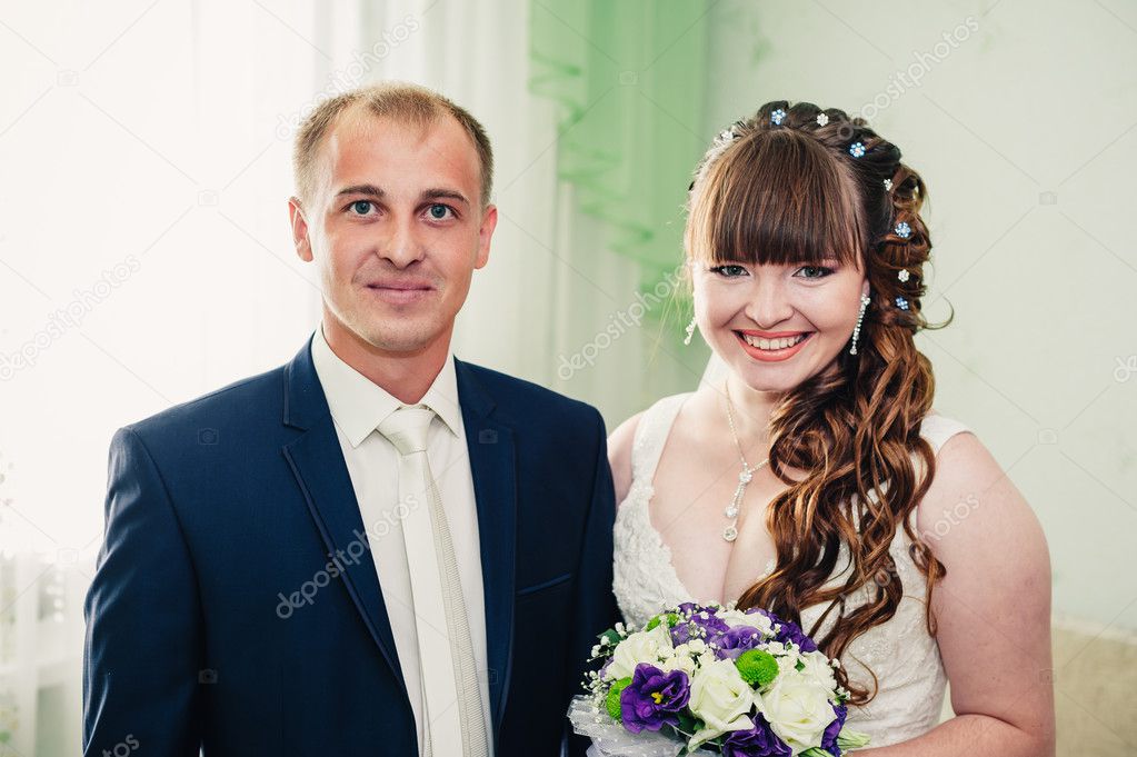 Young wedding couple indoors portrait.