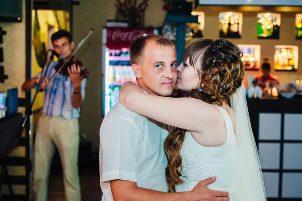 Baile de bodas de novios jóvenes en salón de banquetes. Beso, abrazo —  Fotos de Stock