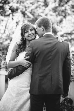 Gelin ve damat gün açık havada yürüyüş düğününde Doğa bahar. Gelin çift, mutlu yeni evli çift yeşil park kucaklayan.