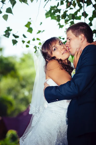 Mariée et marié le jour du mariage Promenade en plein air sur la nature printanière. Couple nuptial, heureux couple nouvellement marié embrassant dans le parc vert . — Photo