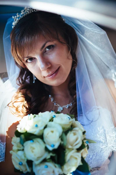 Nahaufnahme Porträt einer ziemlich schüchternen Braut im Autofenster — Stockfoto