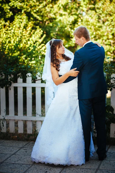 Sposo e Sposo al matrimonio Giorno camminando all'aperto sulla natura primaverile. Coppia nuziale, Felice coppia di sposi che si abbraccia nel parco verde . — Foto Stock