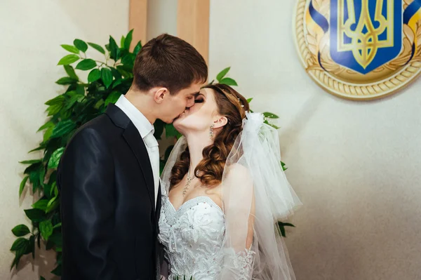 Cerimônia de casamento. Escritório de registo. Um casal recém-casado assina o documento de casamento . — Fotografia de Stock