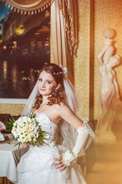 Portret mireasă frumoasă cu buchet de flori pe interior de lux în ziua nunții — Fotografie, imagine de stoc