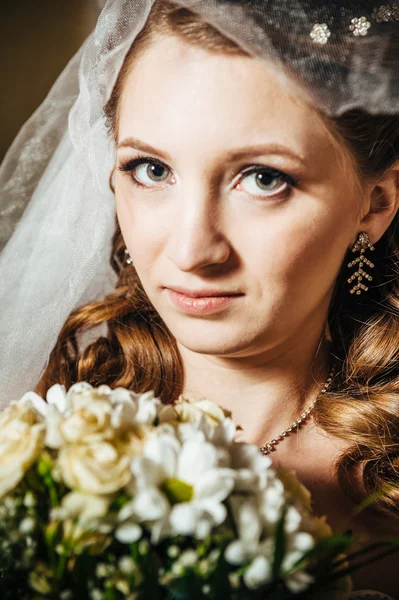 Retrato bela noiva com buquê de flores no interior de luxo no dia do casamento — Fotografia de Stock