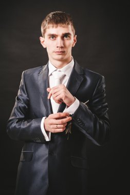 Takım elbiseli hazırlanıyor düğün damat elleri. siyah stüdyo arka plan