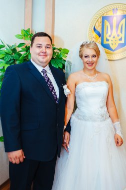 Düğün töreni. Kayıt ofisi. Bir yeni evli çift evlilik belgesi imzalar. Genç çift düğün belgelerin imzalanması