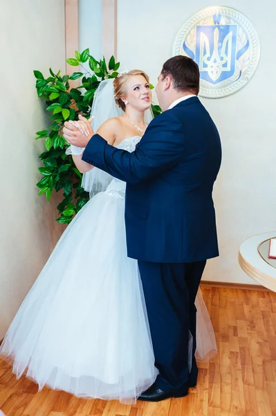 Ceremonia de boda. Oficina de registro. Una pareja de recién casados firma el documento de matrimonio.Pareja joven firma documentos de boda — Foto de Stock