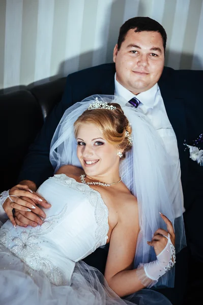 Encantadores novios en la celebración de su boda en un lujoso restaurante. Ramo de flores y vestido de novia. pareja de recién casados en el lujoso hotel moderno hall —  Fotos de Stock