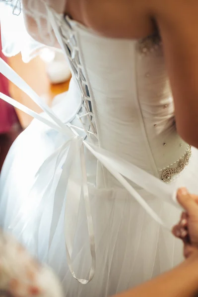 Beautiful bride getting ready in white wedding dress with hairstyle and bright makeup. Happy sexy girl waiting for groom. Romantic lady in bridal dress have final preparation for wedding. — Stock Photo, Image