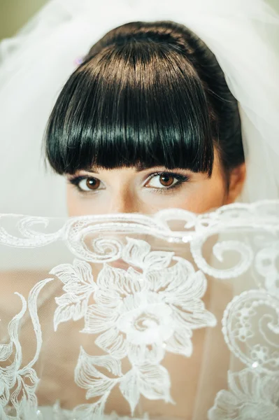 Beautiful bride getting ready in white wedding dress with hairstyle and bright makeup. Happy sexy girl waiting for groom. Romantic lady in bridal dress have final preparation for wedding. — Stock Photo, Image