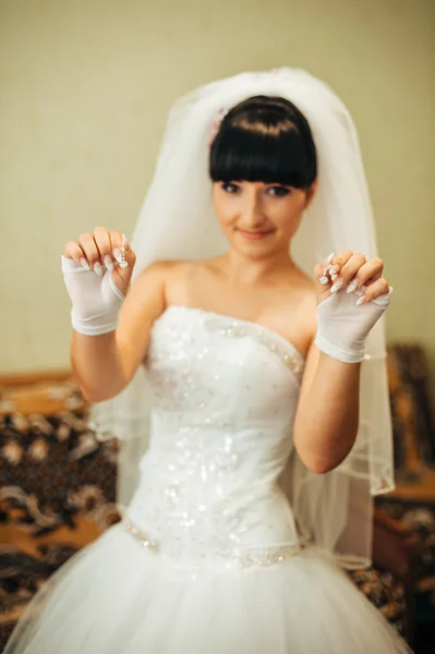 Beautiful bride getting ready in white wedding dress with hairstyle and bright makeup. Happy sexy girl waiting for groom. Romantic lady in bridal dress have final preparation for wedding. — Stock Photo, Image