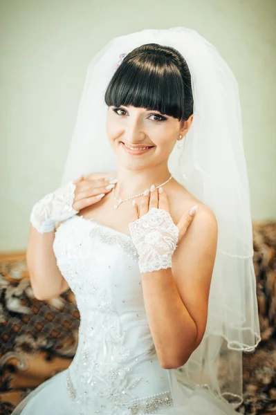 Beautiful bride getting ready in white wedding dress with hairstyle and bright makeup. Happy sexy girl waiting for groom. Romantic lady in bridal dress have final preparation for wedding. — Stock Photo, Image