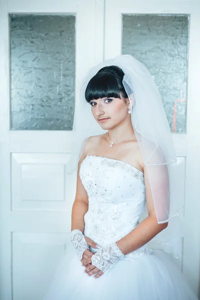 Beautiful bride getting ready in white wedding dress with hairstyle and bright makeup. Happy sexy girl waiting for groom. Romantic lady in bridal dress have final preparation for wedding. — Stock Photo, Image