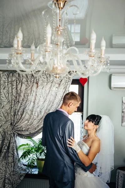 Charming bride and groom on their wedding celebration in a luxurious restaurant. Loving couple on date — Stock Photo, Image