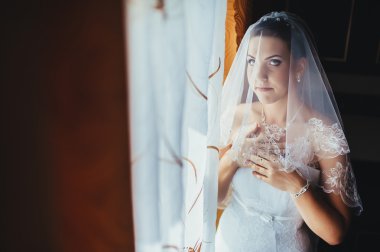 Gelin hazırlanıyor. güzel gelin beyaz düğün elbise parlak makyaj ve saç modeli ile. Damat için bekleyen mutlu seksi kız. Gelin elbiseli romantik Bayan var düğün için son hazırlık ve sunuş