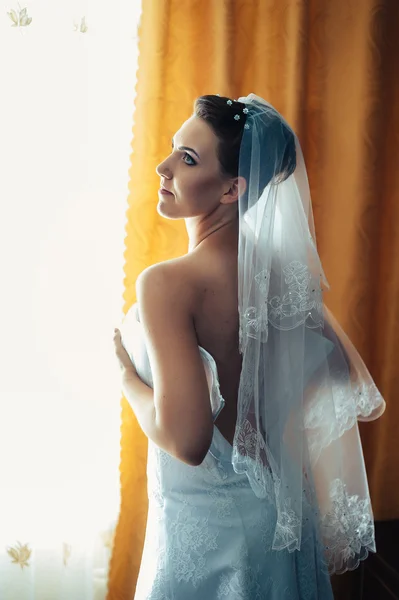 A noiva está a preparar-se. noiva bonita em vestido de noiva branco com penteado e maquiagem brilhante. Menina sexy feliz à espera de noivo. Senhora romântica em vestido de noiva tem preparação final para o casamento — Fotografia de Stock